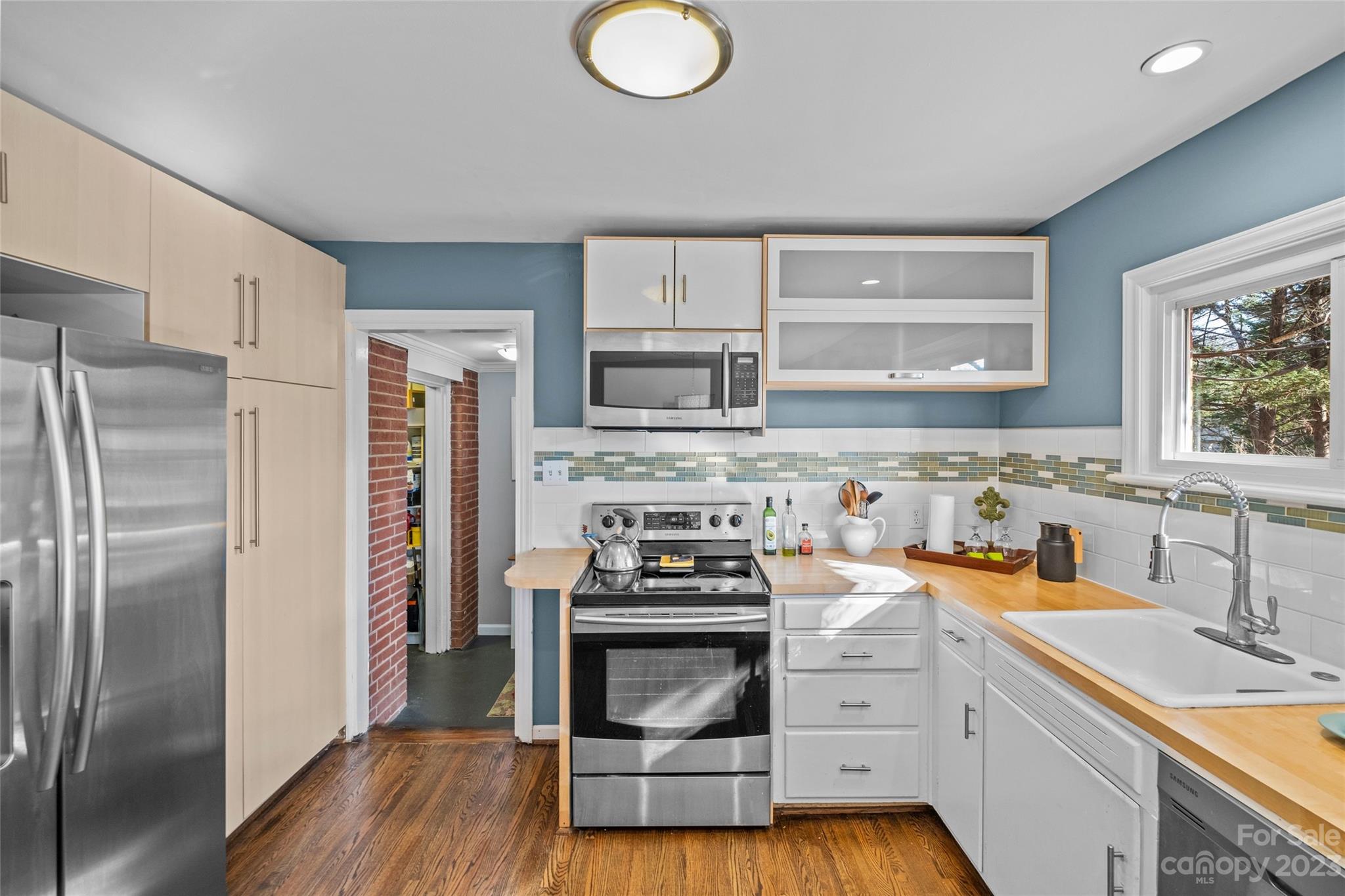 4439 Applegate Road Charlotte, NC 28209 - Photo 8 of 34 a kitchen with a refrigerator sink and stove top oven