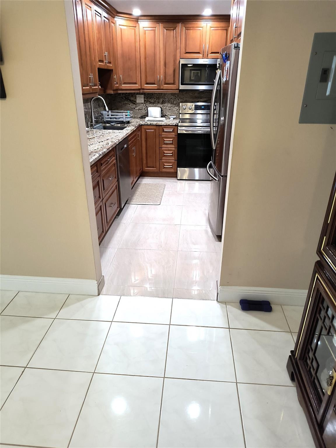 10777 West Sample Road, Unit 402 Coral Springs, FL 33065 - Photo 16 of 27 a kitchen with stainless steel appliances a sink a stove a microwave and a refrigerator