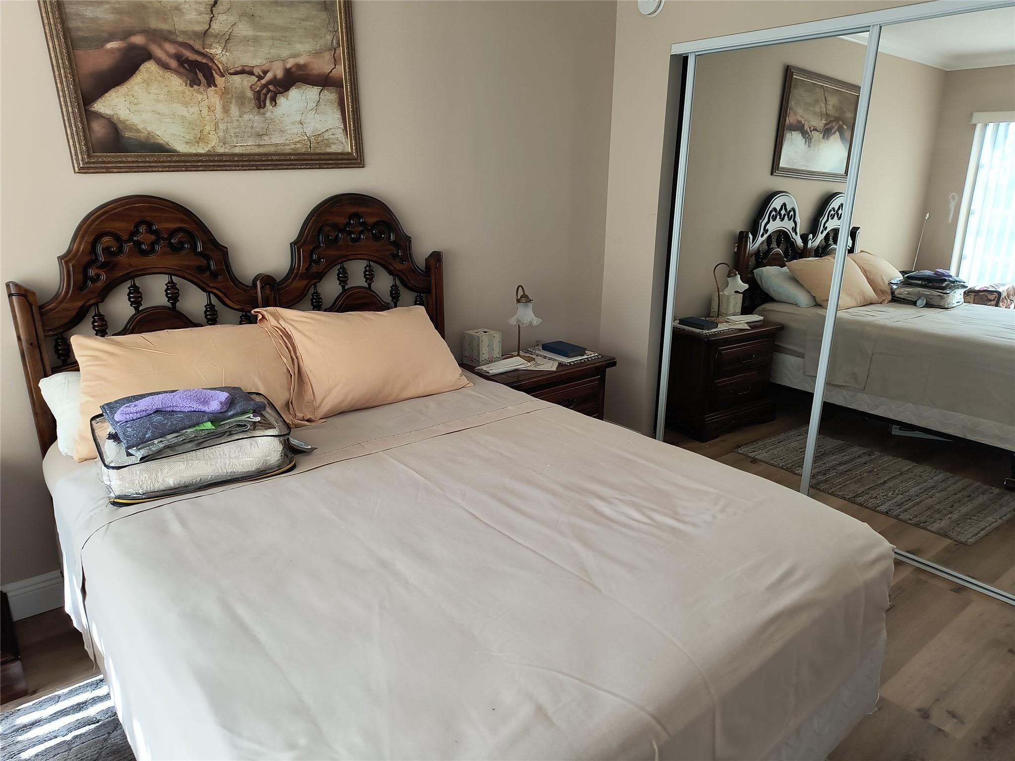 10777 West Sample Road, Unit 402 Coral Springs, FL 33065 - Photo 21 of 27 a bedroom with bed and wall painting