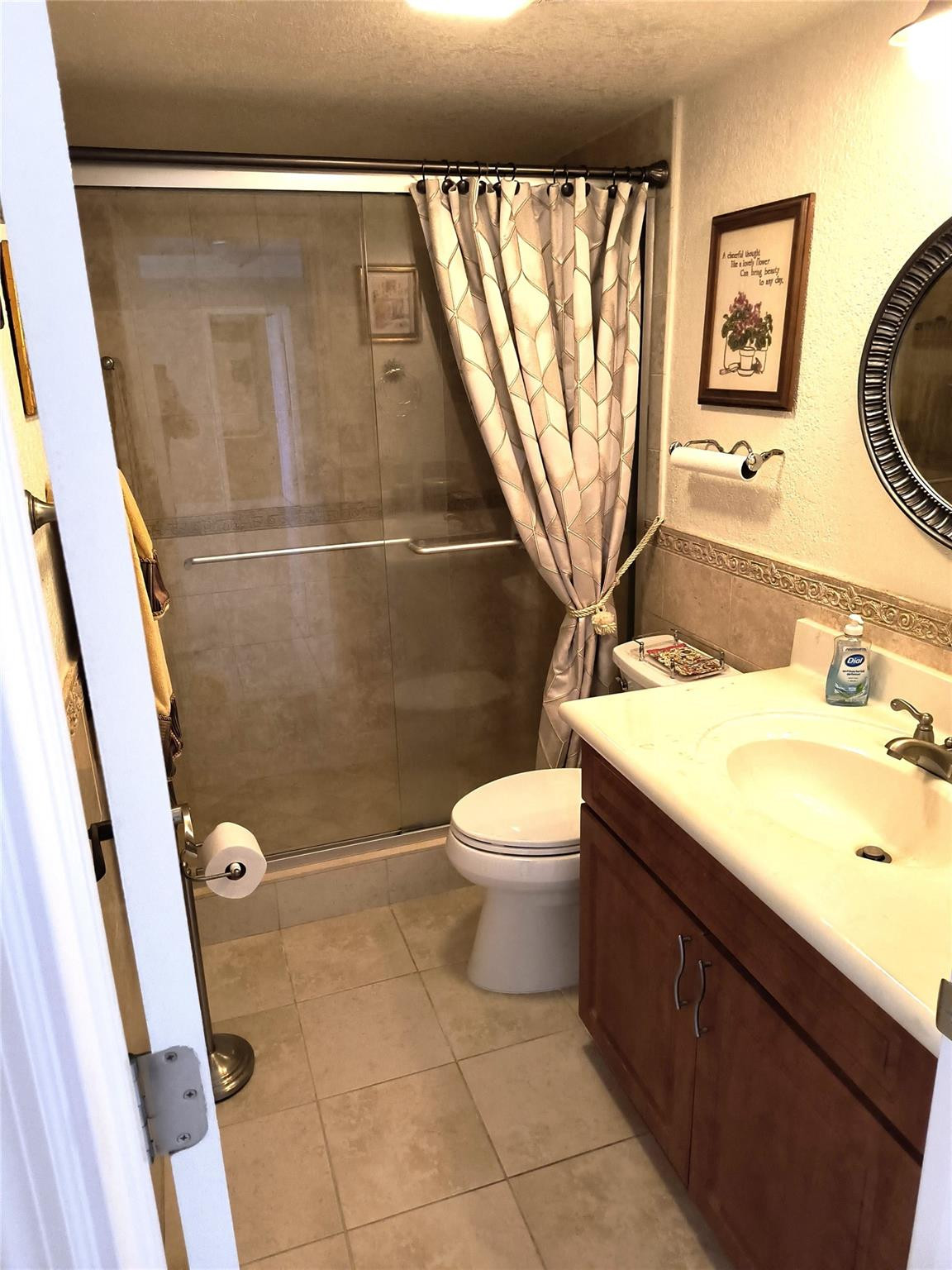 10777 West Sample Road, Unit 402 Coral Springs, FL 33065 - Photo 22 of 27 a bathroom with a toilet sink and mirror