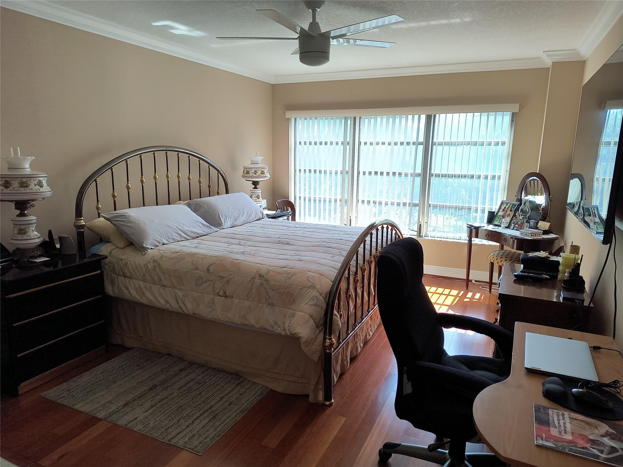 10777 West Sample Road, Unit 402 Coral Springs, FL 33065 - Photo 24 of 27 a bedroom with a bed chair and a large window