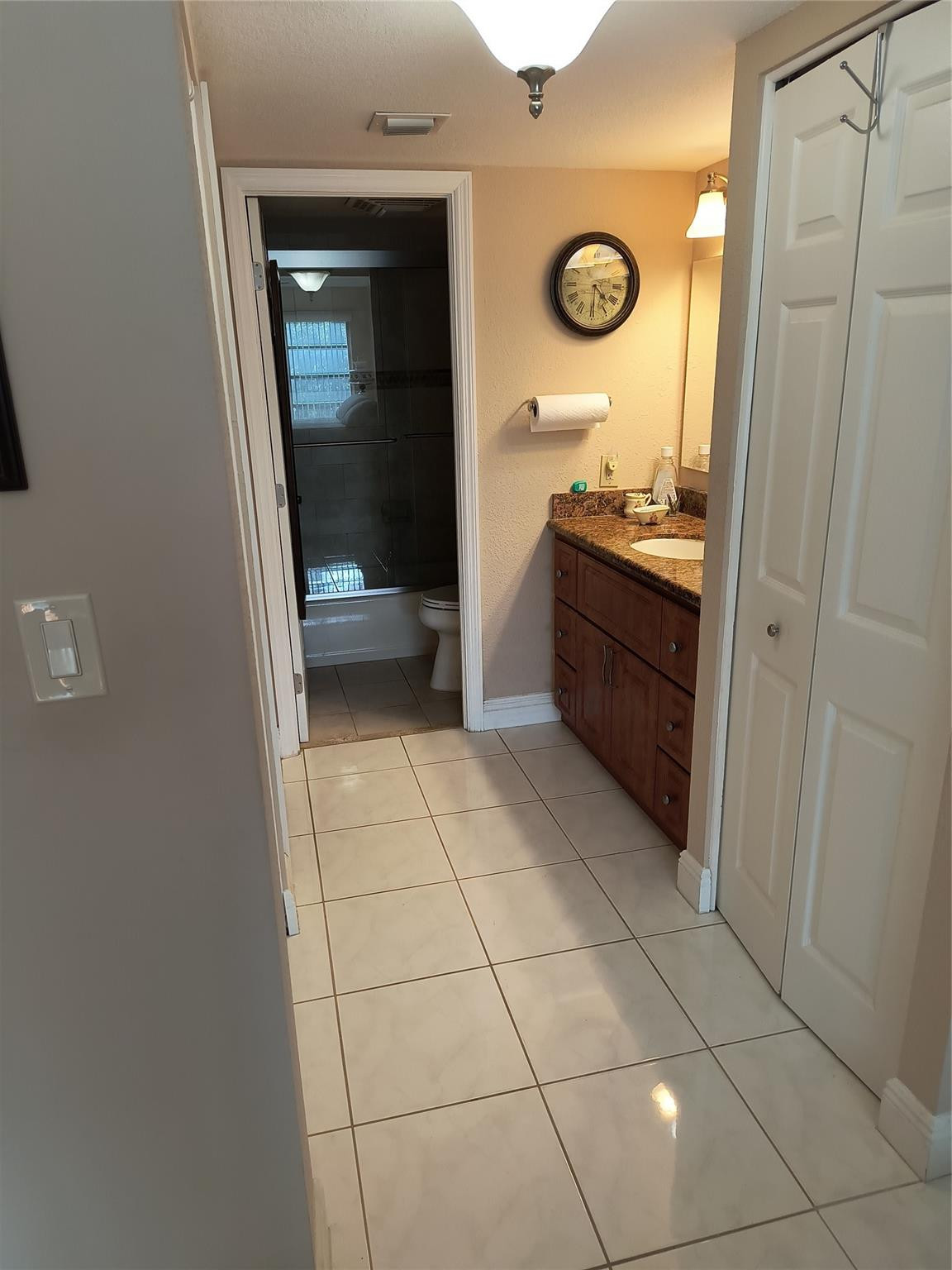 10777 West Sample Road, Unit 402 Coral Springs, FL 33065 - Photo 25 of 27 a bathroom with a granite countertop sink a toilet and a mirror