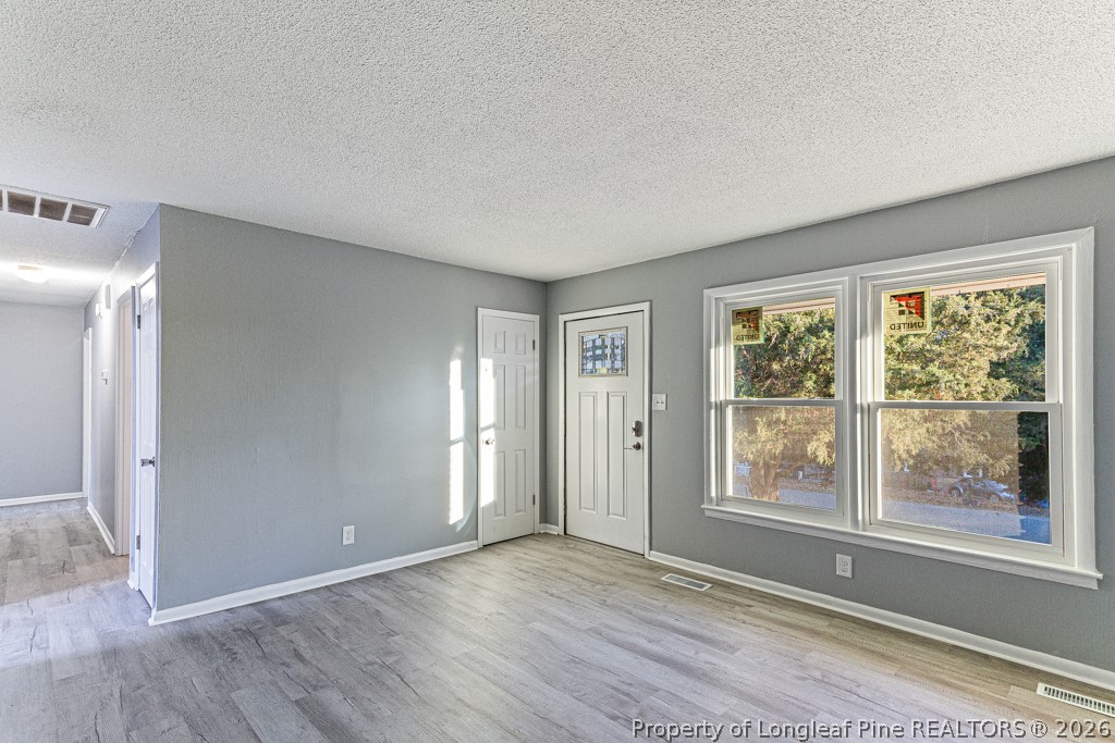 922 Rancho Drive Fayetteville, NC 28303 - Photo 9 of 21 a view of an empty room with wooden floor and a window