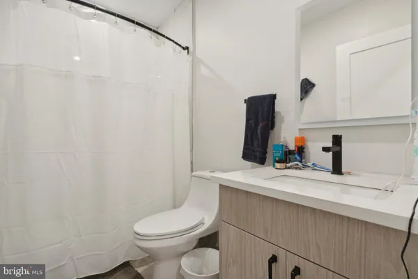a bathroom with a sink a toilet and mirror
