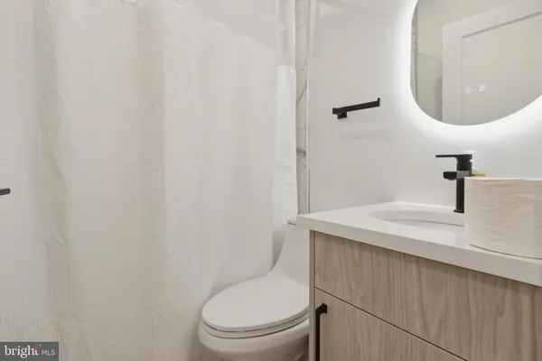 a white toilet sitting next to a bathroom sink