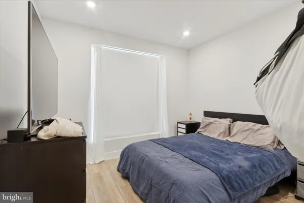 a bedroom with a bed and a mirror