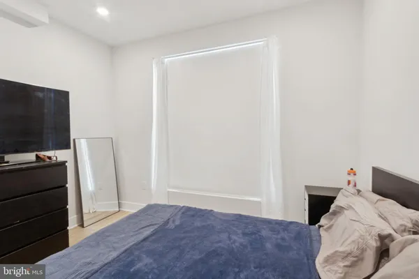 a bedroom with a bed and a television in it