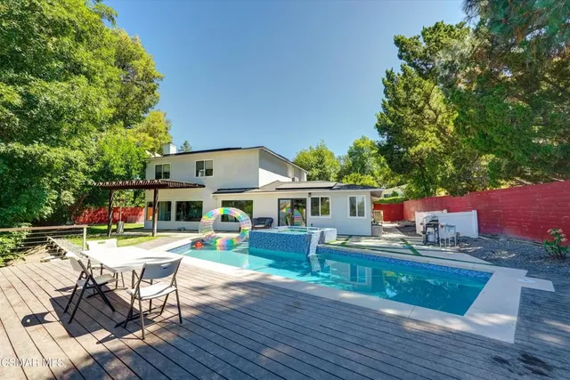 a view of a house with a yard and sitting area