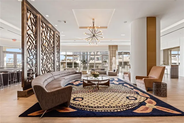 a living room with furniture windows and a table