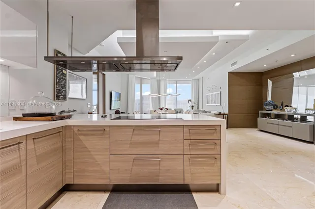 a large white kitchen with a large window a sink and stainless steel appliances