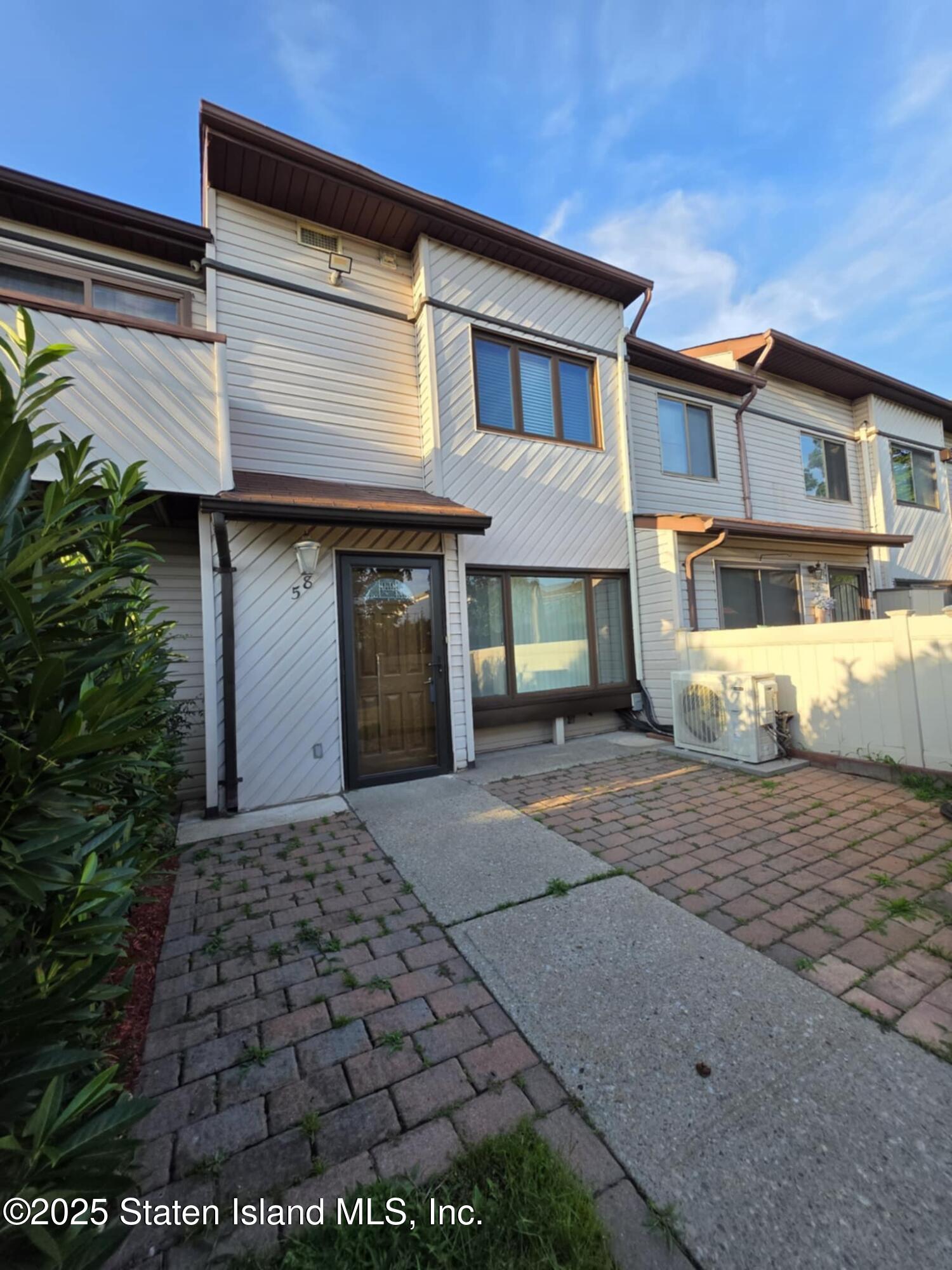 58 Selvin Loop Staten Island, NY 10303 - Photo 1 of 19 a front view of a house with a yard