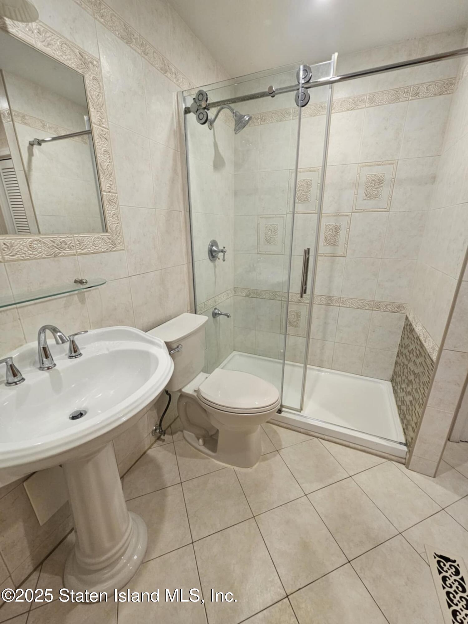 58 Selvin Loop Staten Island, NY 10303 - Photo 14 of 19 a bathroom with a sink toilet and shower
