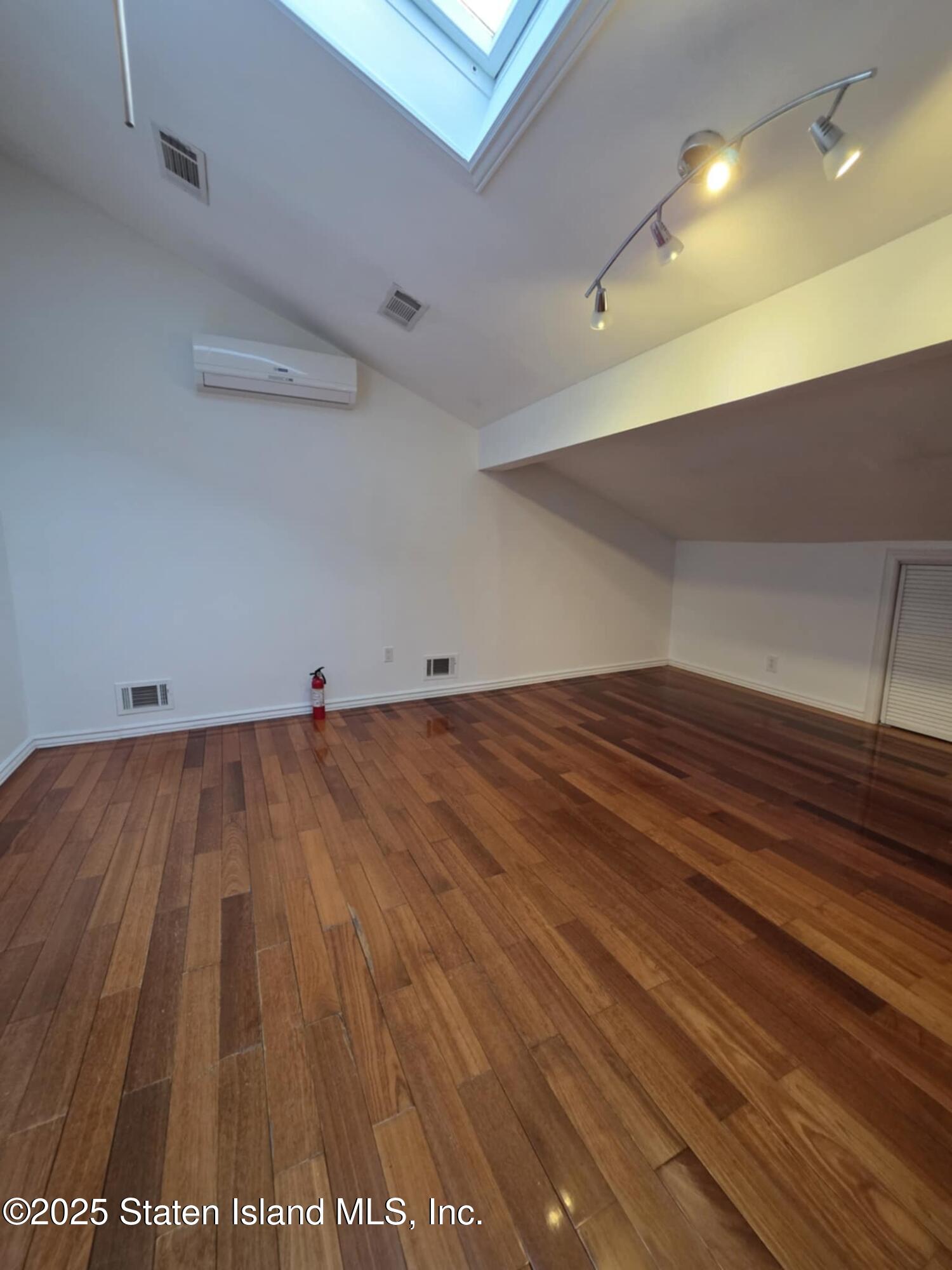 58 Selvin Loop Staten Island, NY 10303 - Photo 16 of 19 a view of room with wooden floor