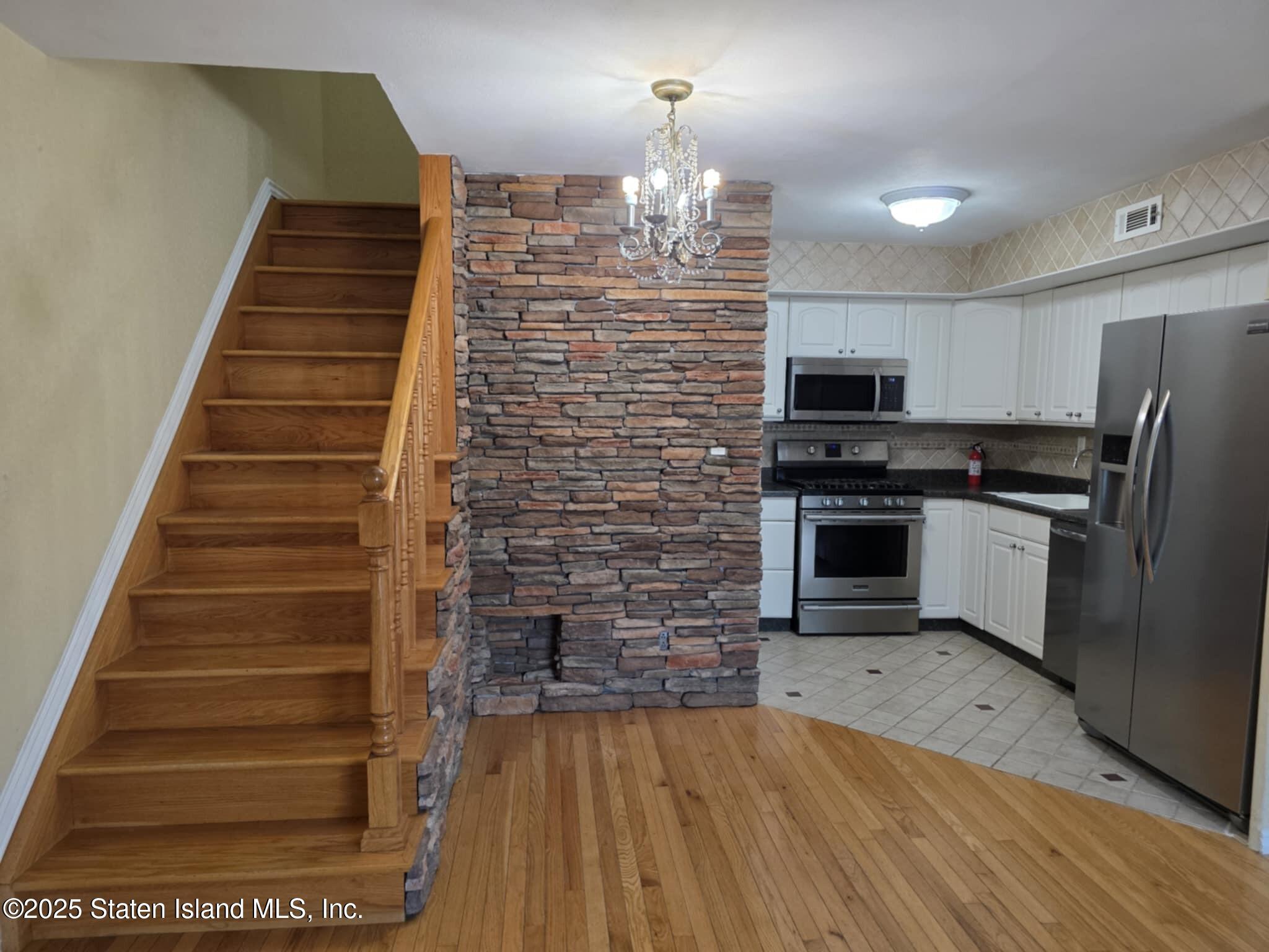 58 Selvin Loop Staten Island, NY 10303 - Photo 7 of 19 a kitchen with stainless steel appliances a stove and a refrigerator