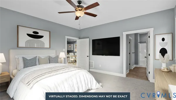 a bedroom with a bed and a flat tv screen on dresser