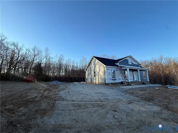 a view of a house with a yard and tree s