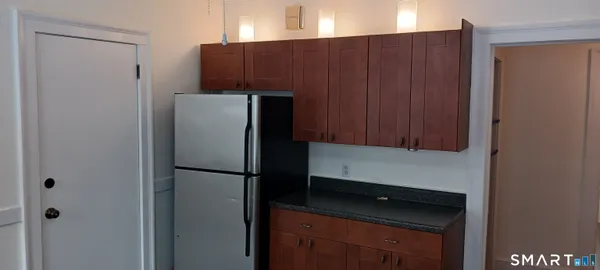 a kitchen with a refrigerator and a cabinets