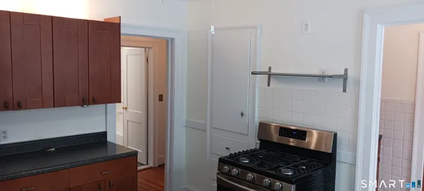 a kitchen with a refrigerator and a stove