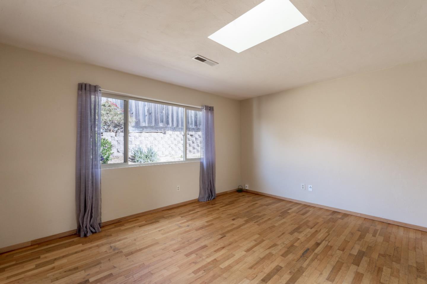 301 Park Circle Marina, CA 93933 - Photo 2 of 18 an empty room with wooden floor and windows