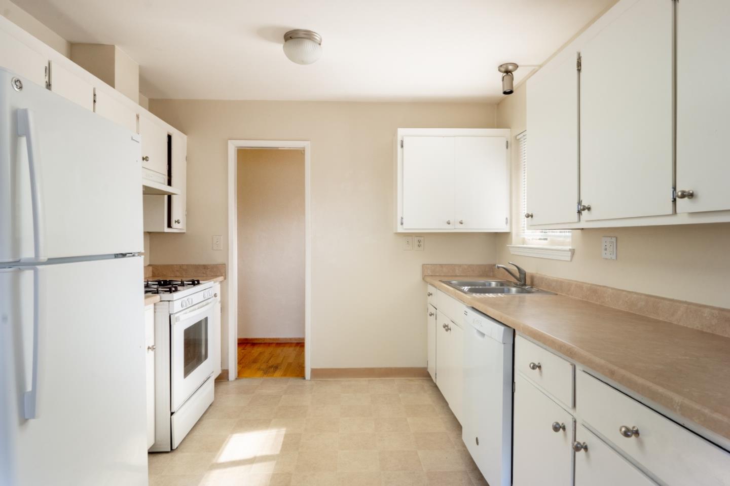 301 Park Circle Marina, CA 93933 - Photo 7 of 18 a kitchen with stainless steel appliances granite countertop a refrigerator a stove and white cabinets