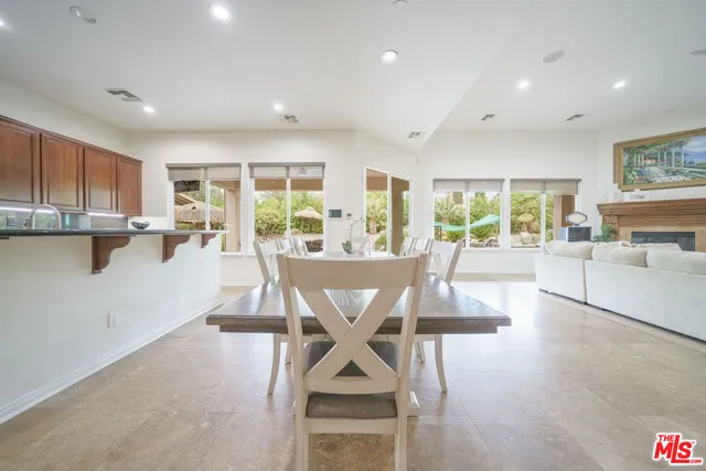 a view of a hallway with wooden floor and a bathroom