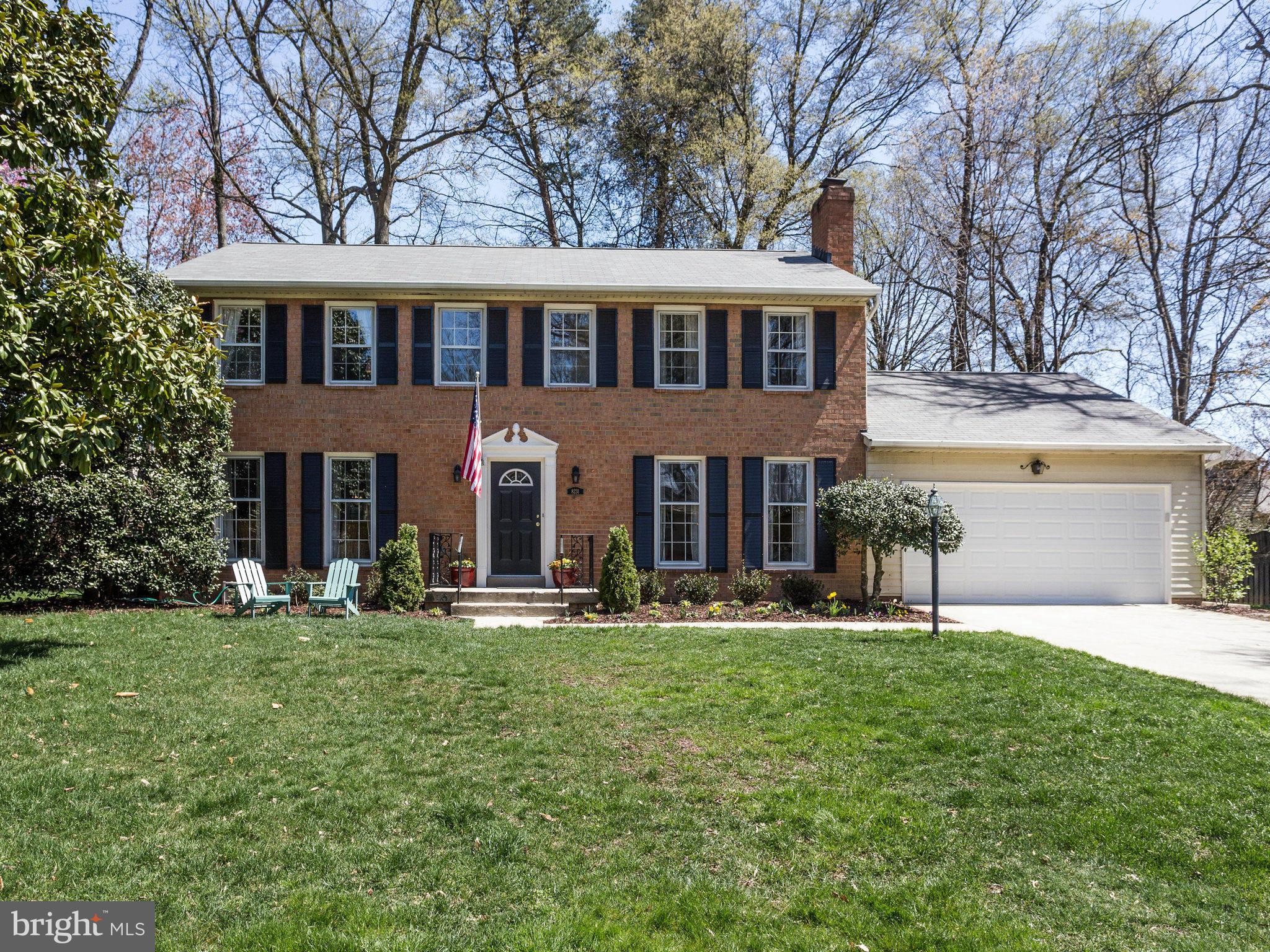 a backyard of a house with outdoor seating and trees