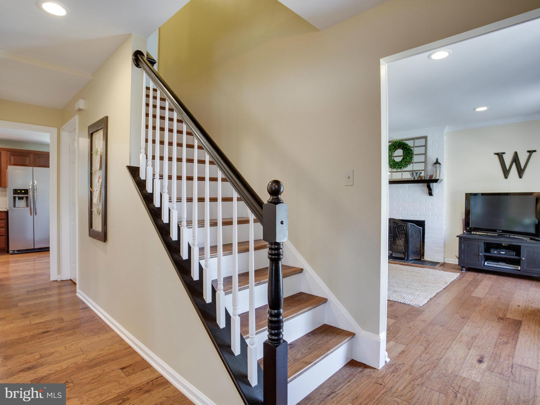 8231 Crown Court Road Alexandria, VA 22308 - Photo 15 of 30 a view of a livingroom with wooden floor and staircase