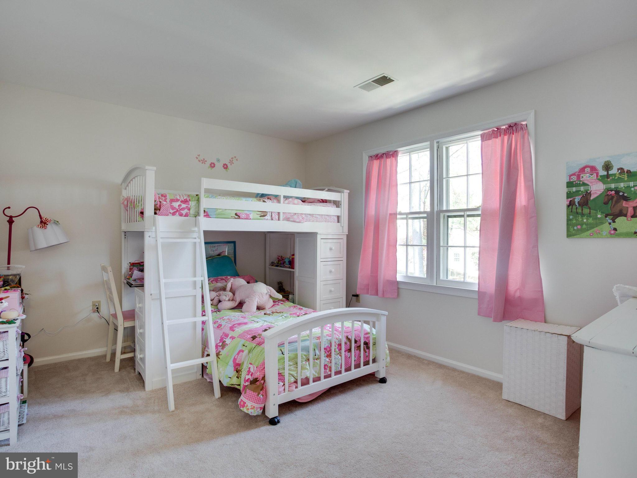 8231 Crown Court Road Alexandria, VA 22308 - Photo 22 of 30 a bedroom with a bed and a window