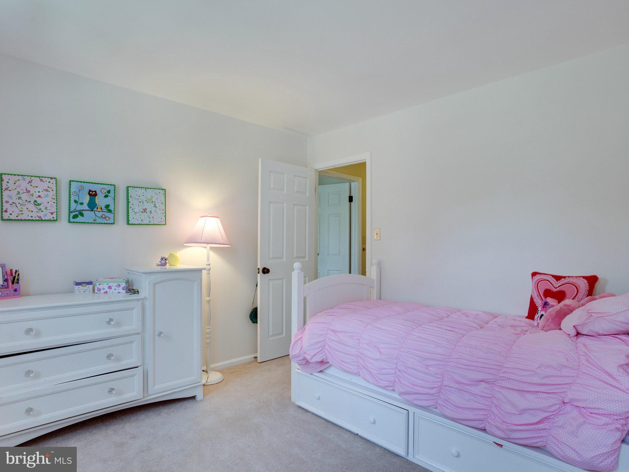 8231 Crown Court Road Alexandria, VA 22308 - Photo 23 of 30 a bedroom with a bed and a dresser in it