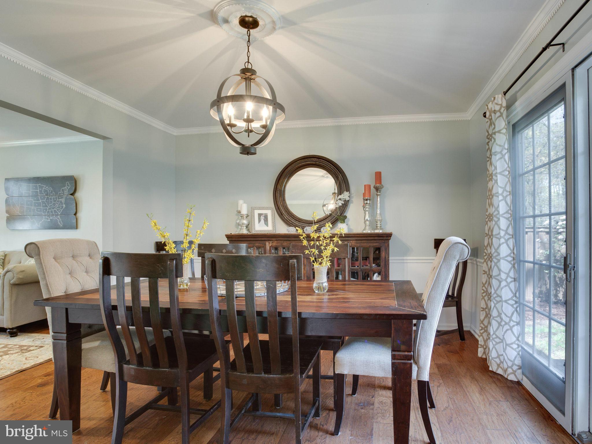 8231 Crown Court Road Alexandria, VA 22308 - Photo 10 of 30 a view of a dining room with furniture window and wooden floor