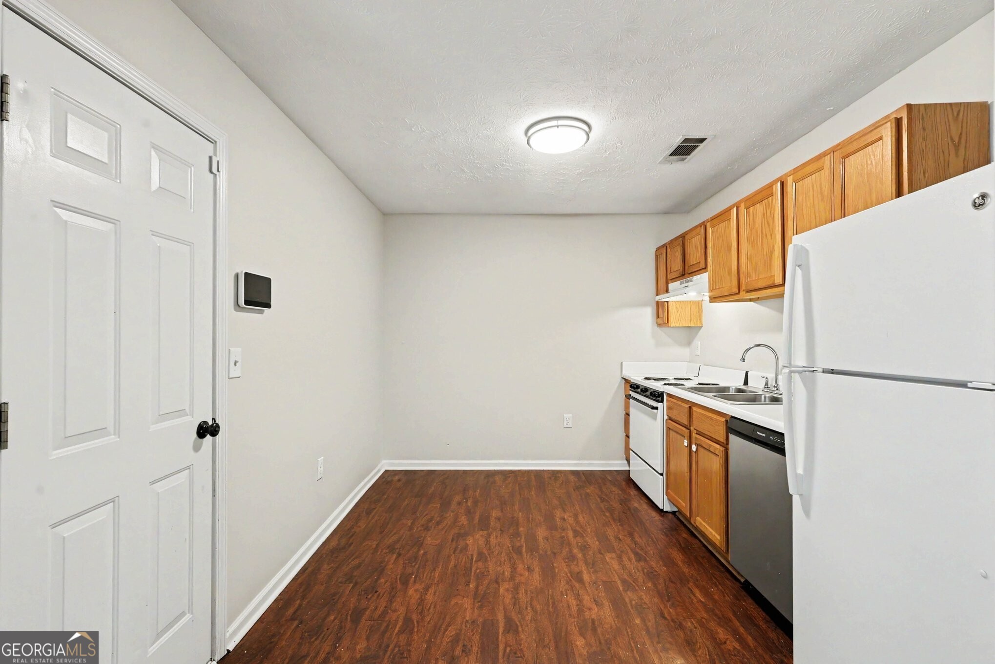 209 East Wilson Street Villa Rica, GA 30180 - Photo 9 of 24 THE EAT-IN KITCHEN IS RIGHT OFF OF THE GARAGE FOR CONVENIENCE.