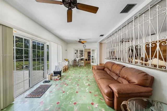 a kitchen filled with stainless steel appliances kitchen island granite countertop a stove and a refrigerator
