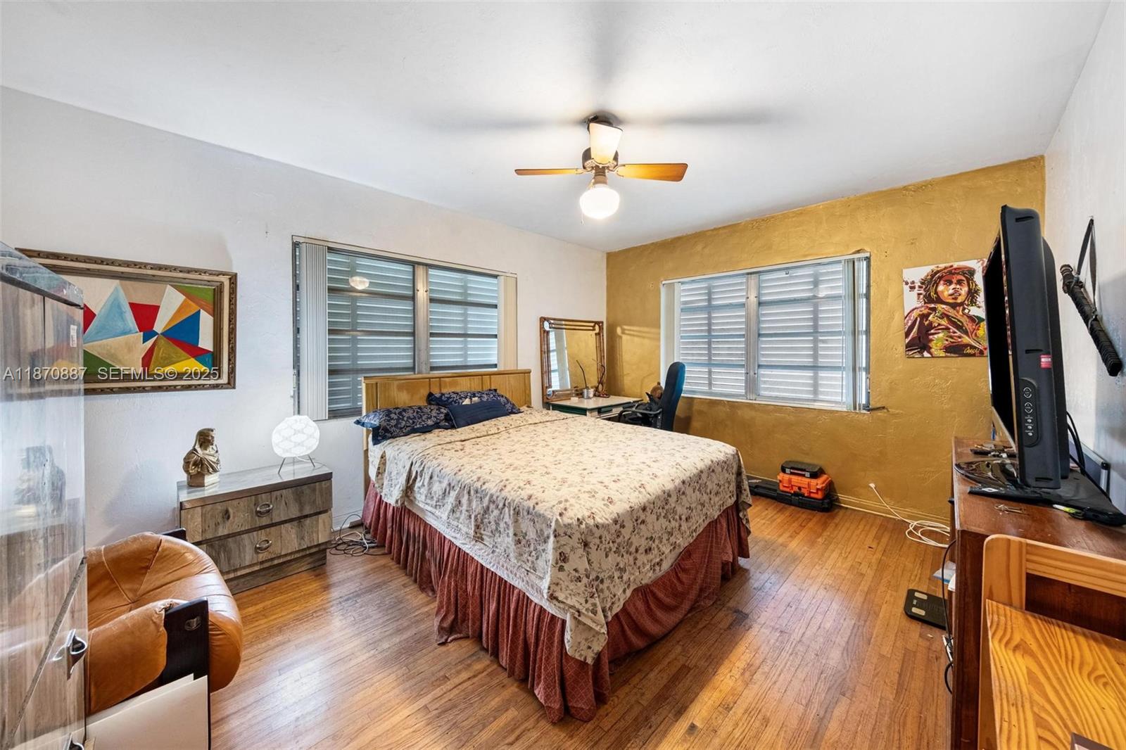 14150 Northwest 2nd Avenue Miami, FL 33168 - Photo 18 of 38 a bedroom with a bed and wooden floor