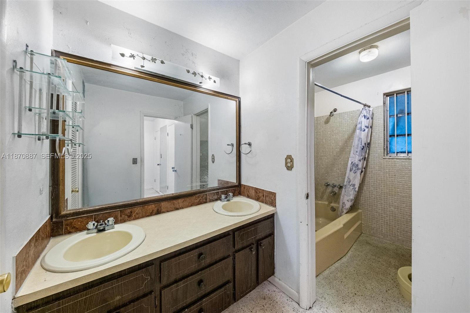 14150 Northwest 2nd Avenue Miami, FL 33168 - Photo 28 of 38 a bathroom with a granite countertop sink double vanity and a mirror