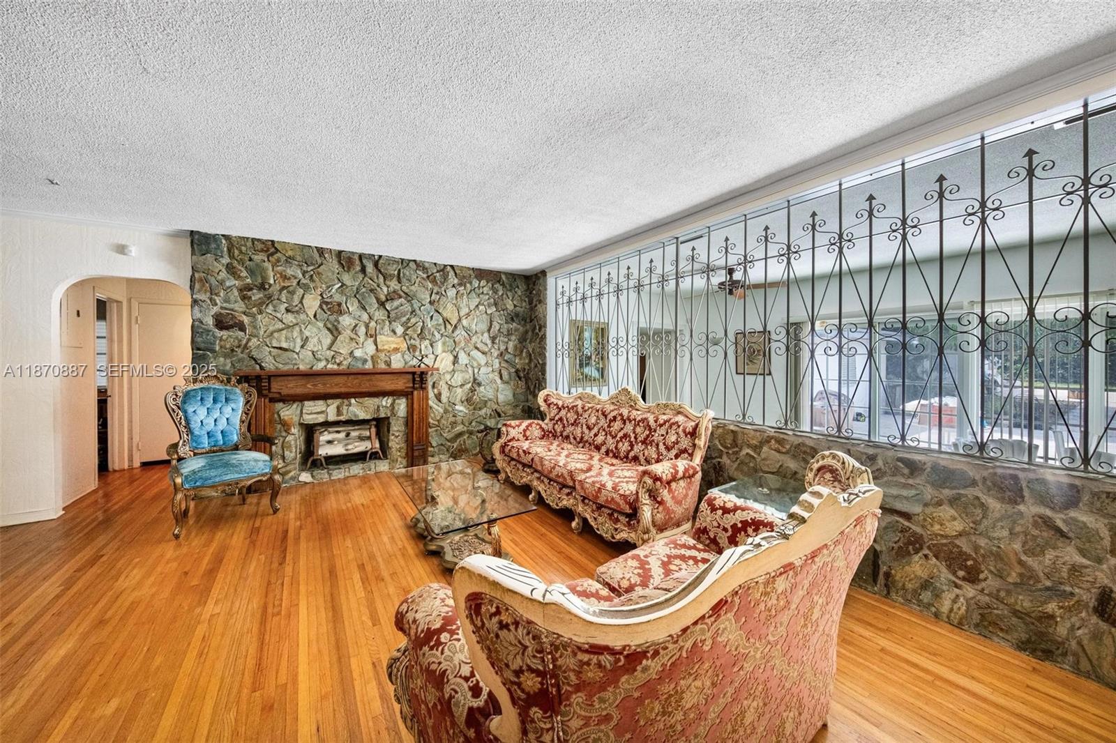 14150 Northwest 2nd Avenue Miami, FL 33168 - Photo 7 of 38 a living room with furniture and a fireplace