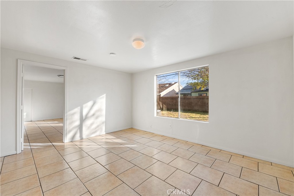 1252 East Ave R 6 Palmdale, CA 93550 - Photo 18 of 40 a view of an empty room with a window