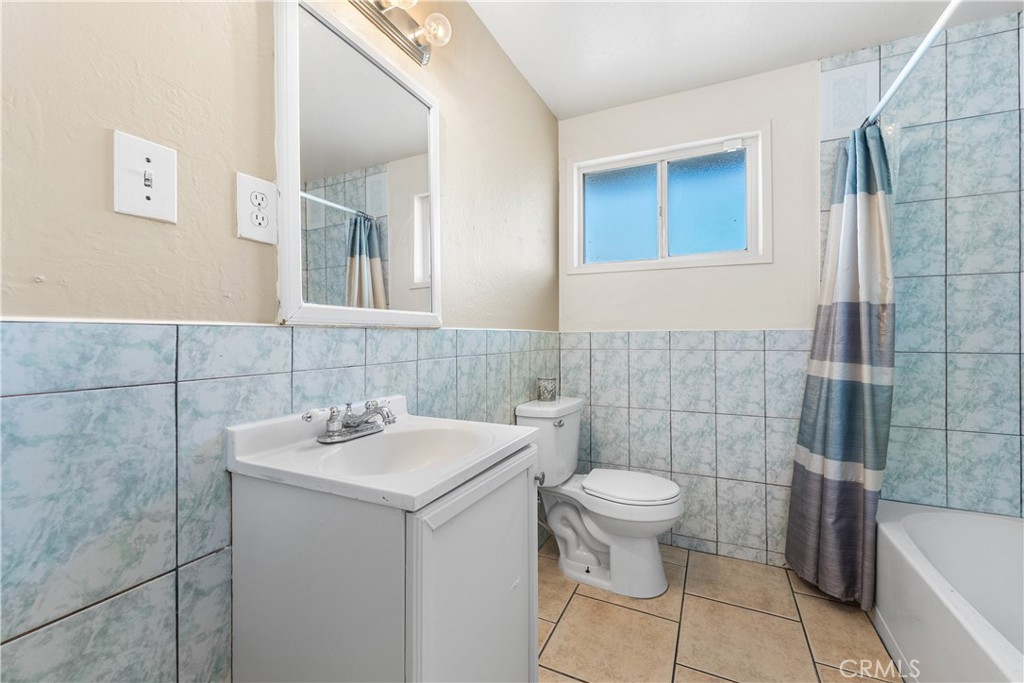 1252 East Ave R 6 Palmdale, CA 93550 - Photo 22 of 40 a bathroom with a sink toilet and shower