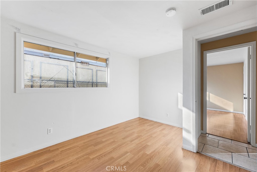 1252 East Ave R 6 Palmdale, CA 93550 - Photo 29 of 40 an empty room with wooden floor and a window