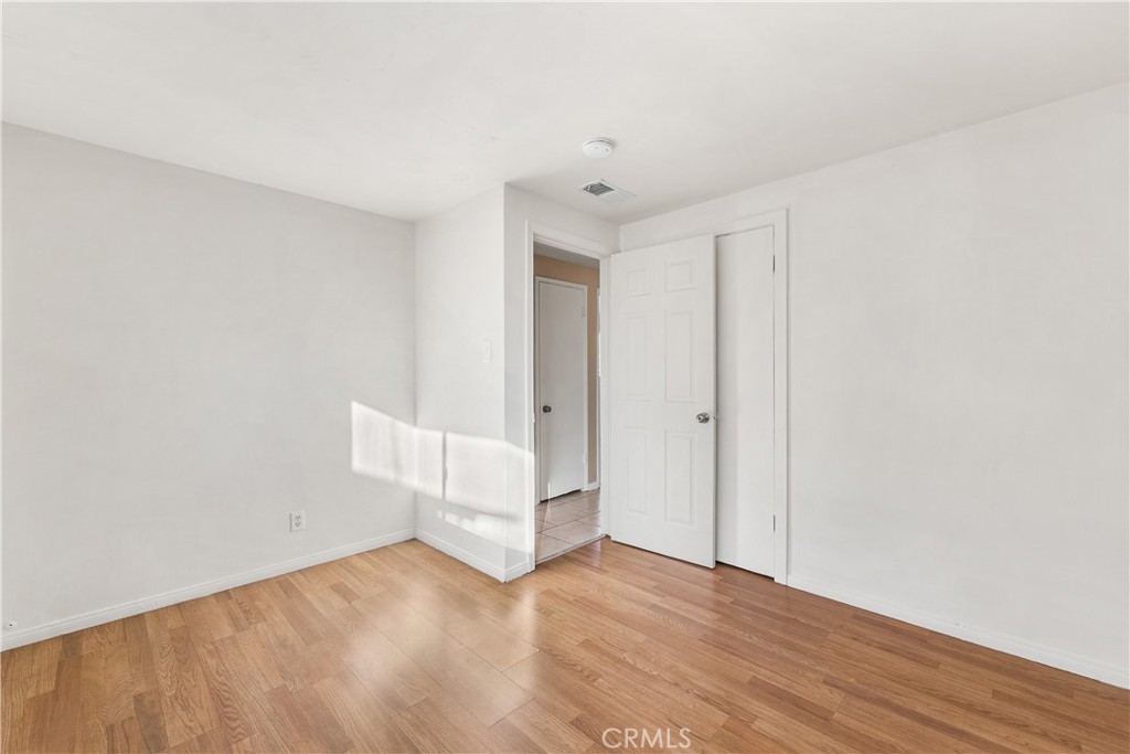 1252 East Ave R 6 Palmdale, CA 93550 - Photo 30 of 40 a view of wooden floor and windows in a room