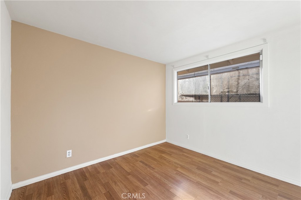 1252 East Ave R 6 Palmdale, CA 93550 - Photo 31 of 40 a view of empty room with wooden floor and fan