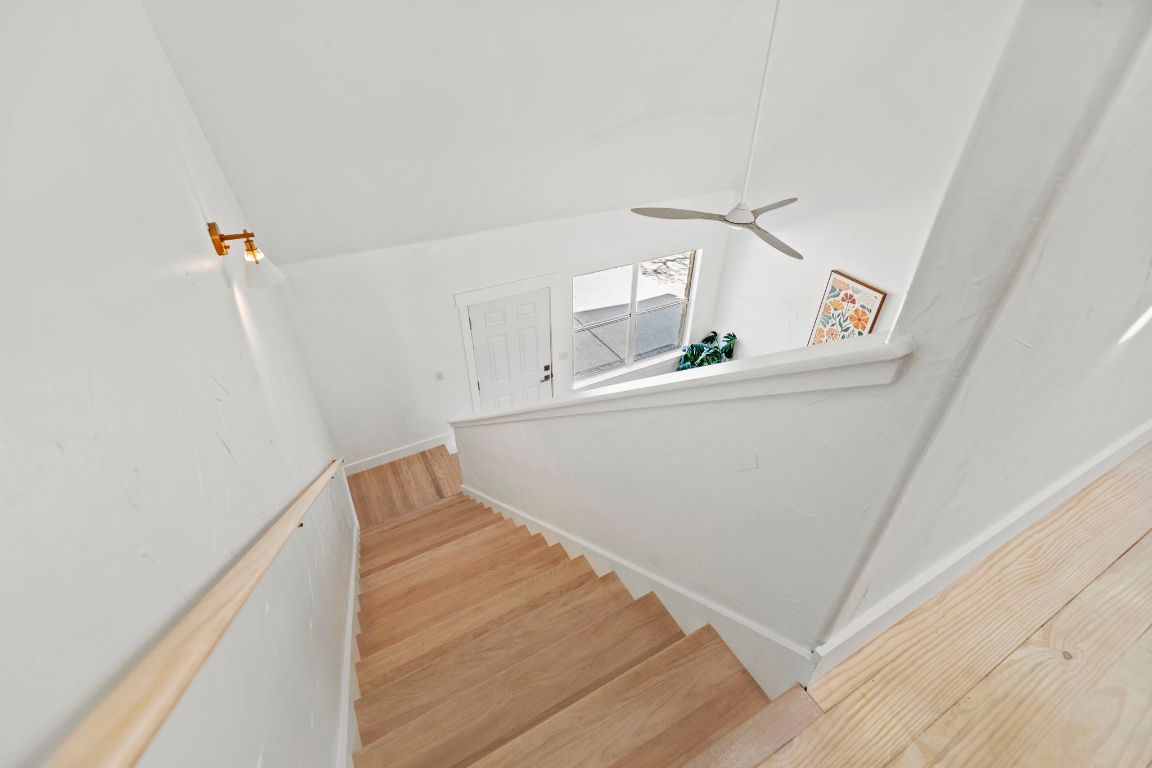 7197 Mt Sharp Road Wimberley, TX 78676 - Photo 17 of 39 a view of hallway with stairs and wooden floor