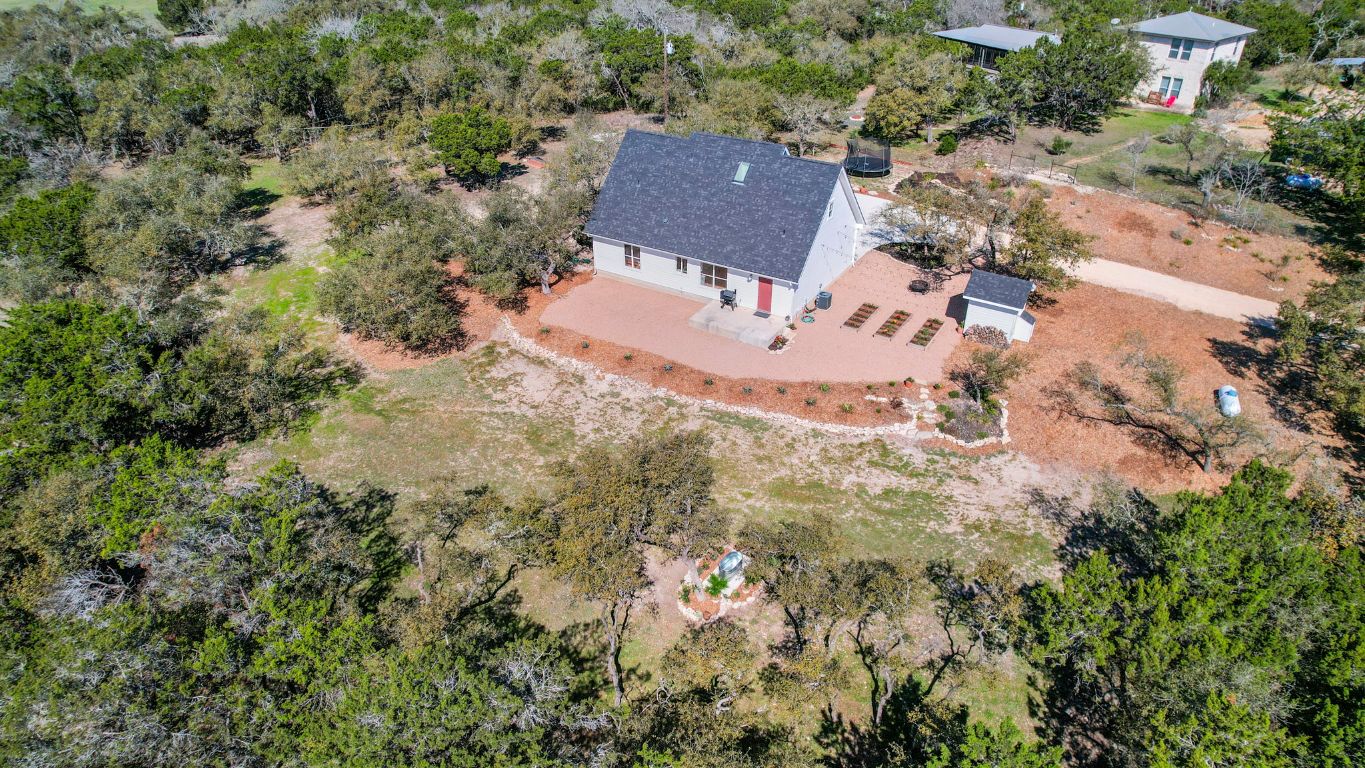 7197 Mt Sharp Road Wimberley, TX 78676 - Photo 35 of 39 an aerial view of house with yard and trees in the background