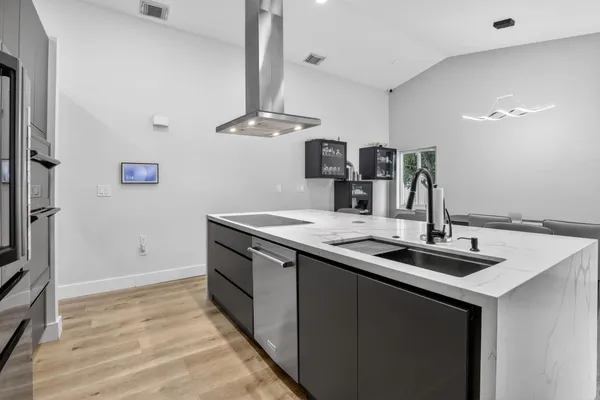 a kitchen with stainless steel appliances a sink and a refrigerator