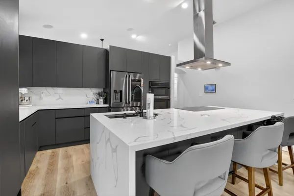 a kitchen with kitchen island a sink table and chairs