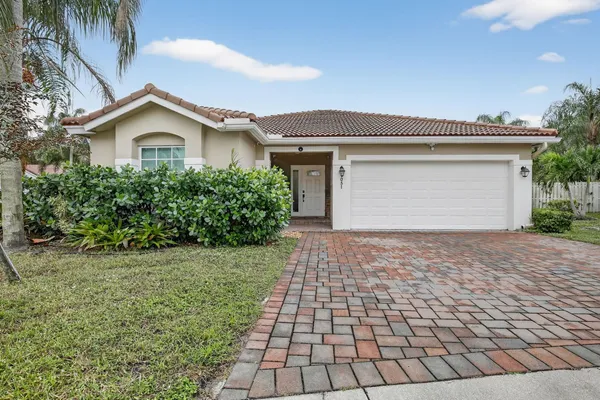 a view of front a house with a yard and a garage