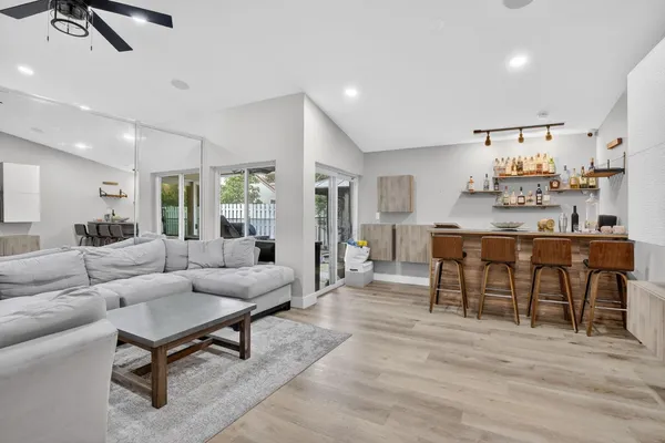 a living room with furniture and view of kitchen