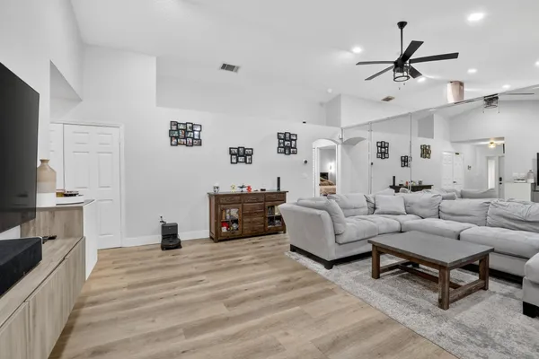 a living room with furniture a fireplace and a flat screen tv