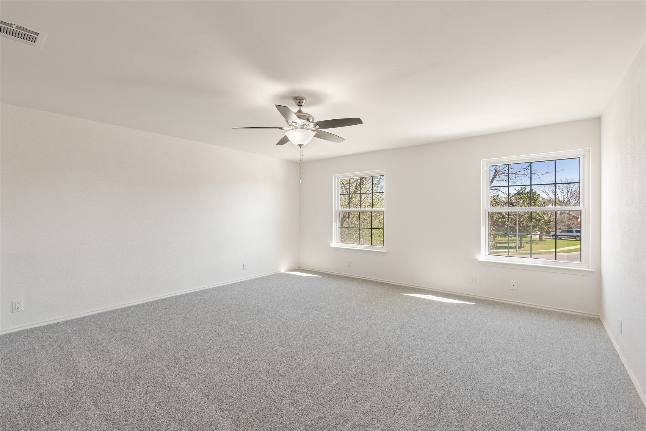1011 Hayden Way Round Rock, TX 78664 - Photo 11 of 23 an empty room with windows and fan