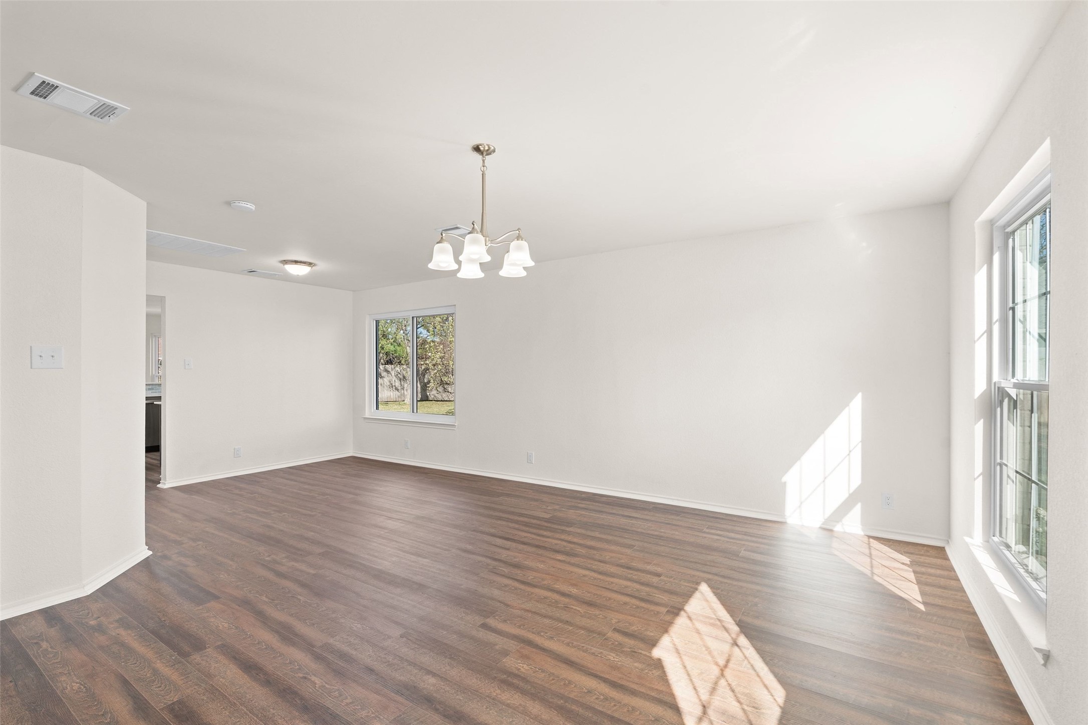 1011 Hayden Way Round Rock, TX 78664 - Photo 5 of 23 an empty room with wooden floor and windows