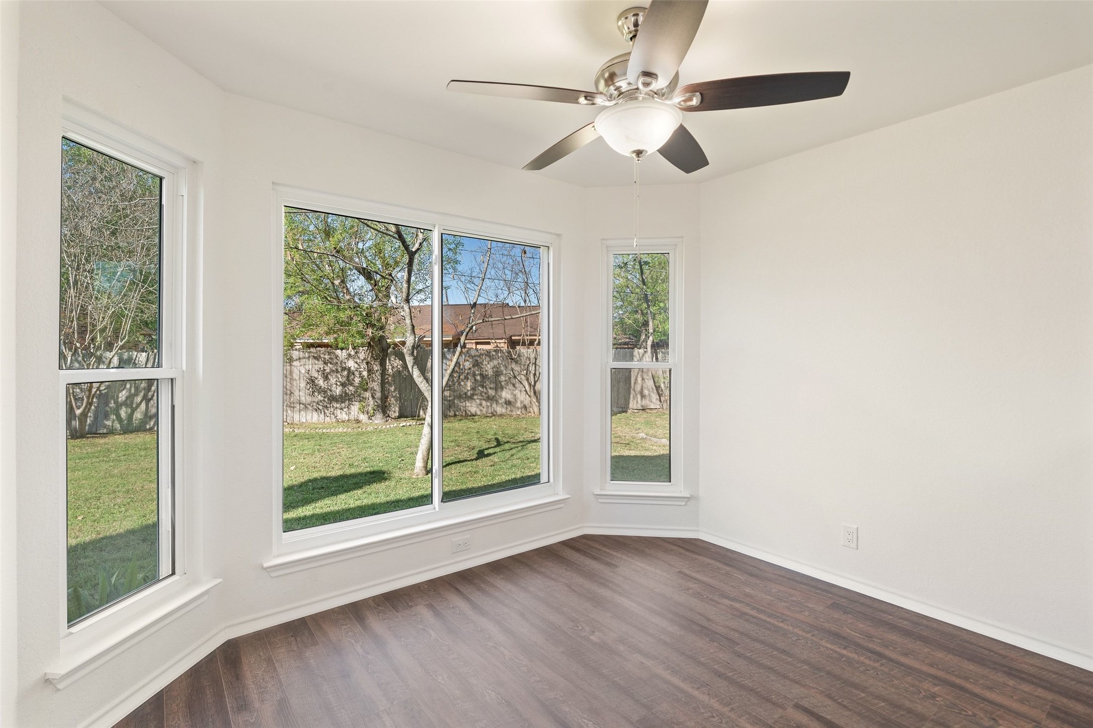 1011 Hayden Way Round Rock, TX 78664 - Photo 9 of 23 an empty room with wooden floor fan and windows